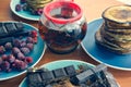 still life on blue plates pancakes with peas, grated chocolate, chocolate bars, brewed tea Royalty Free Stock Photo