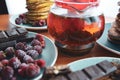 still life on blue plates pancakes with peas, grated chocolate, chocolate bars, brewed tea Royalty Free Stock Photo