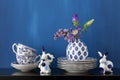 Still life with blue and white dishes and flowers in a little va