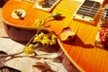 Still life with blues vintage electric guitar, dried flowers and old sheet music close up