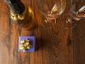 Still life, Bottle of sparking wine decorated with tow golden heart for Saint Valentine day, Blue gift box and two glasses on a Royalty Free Stock Photo