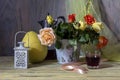 Still life with a bouquet of roses and a glass of homemade wine