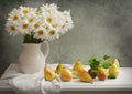 Still life with bouquet of daisy flowers and fresh pears Royalty Free Stock Photo