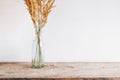 Still life of a bouquet of dried flowers in a glass bottle on a wooden table. Place for text or advertising. View from above Royalty Free Stock Photo