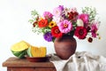 still life with a bouquet of flowers in a clay jug and pieces of pumpkin