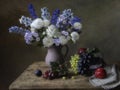 Still life with bouquet of garden flowers and forest fruits Royalty Free Stock Photo