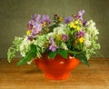 Still life. Bouquet of meadow flowers in orange pots Royalty Free Stock Photo