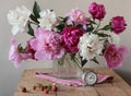 Still-life with a bouquet of peonies and strawberries. Royalty Free Stock Photo