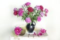 Beautiful still life with a bouquet of red carnations in a vase on the table Royalty Free Stock Photo