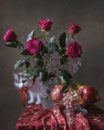 Still life with bouquet of roses and fruits and curious kitty