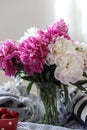 a still life with a bouquet of white and pink peonies and strawberries Royalty Free Stock Photo