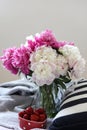 a still life with a bouquet of white and pink peonies and strawberries Royalty Free Stock Photo