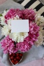 a still life with a bouquet of white and pink peonies and strawberries Royalty Free Stock Photo
