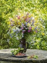 Still life with bouquet of wild flowers and strawberries Royalty Free Stock Photo