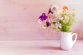 Still life, a bouquet of wild flowers in a white jug. Bouquet of daisies, dandelions and bluebells Royalty Free Stock Photo