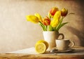 Still life bouquet yellow tulips cup of tea Royalty Free Stock Photo