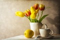 Still life bouquet yellow tulips cup of tea Royalty Free Stock Photo