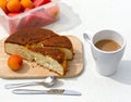 Still life with a bowl with apricots,  pie, coffee on a wooden table close-up. Royalty Free Stock Photo