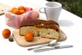 Still life with a bowl with apricots,  pie, coffee on a wooden table close-up. Royalty Free Stock Photo