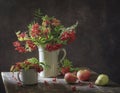 Still life with branches with berries red rowan in white vintage jug Royalty Free Stock Photo