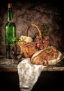 Still life bread in basket and bottle o Royalty Free Stock Photo