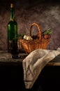 Still life bread in basket and bottle o Royalty Free Stock Photo