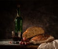 Still life bread in basket and bottle of wine Royalty Free Stock Photo