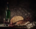 Still life bread in basket and bottle of wine Royalty Free Stock Photo