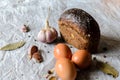 Still life of bread, eggs, garlic and spices. Royalty Free Stock Photo