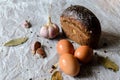 Still life of bread, eggs, garlic and spices. Royalty Free Stock Photo