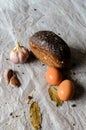 Still life of bread, eggs, garlic and spices. Royalty Free Stock Photo