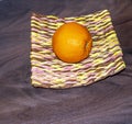 Still life. Bright yellow orange on a handmade plate.
