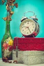 Still life with broken alarm clock, metal cross with metal necklace, old glass vase with dead rose, vintage boxs, tone image. Royalty Free Stock Photo