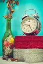 Still life with broken alarm clock, metal cross with metal necklace, old glass vase with dead rose, vintage boxs, tone image. Royalty Free Stock Photo