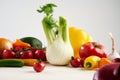 Still life of a bunch fresh different seasonal green vegetables avocado, fennel, garlic, onion, tomato, red yellow pepper. Royalty Free Stock Photo