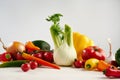 Still life of a bunch fresh different seasonal green vegetables avocado, fennel, garlic, onion, tomato, red yellow pepper. Royalty Free Stock Photo