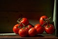 Still Life with a bunch of natural grown Tomatoes. Rustic wood background, antique wooden table Royalty Free Stock Photo