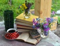 Still life with bunch of spring flowers, books, cup of tea and open diary on the table Royalty Free Stock Photo