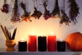 Still life with burning candles, dry herbs and pumpkin on witch table Royalty Free Stock Photo