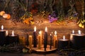 Still life with burning candles and dry herbs on witch table Royalty Free Stock Photo