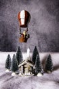 Still life cabin in snowy woods with Santa Claus overhead Royalty Free Stock Photo