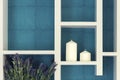 Still life of candle with flower on shelve