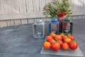 Still life, Candlesticks, vase with yellow flowers and rowan, fresh tomatoes.Concept, autumn harvest, vegetables without