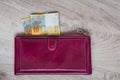 Still life of cash. Bordeaux leather wallet and Swiss francs on a wooden background Royalty Free Stock Photo