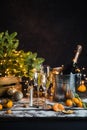 Still life with champagne bottle standing in a bucket with ice, two full flutes, LED lights and Royalty Free Stock Photo