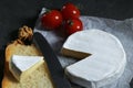 Still life with cheese on a dark background