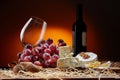 Still-life with cheese, grapes and glass and bottle of red wine Royalty Free Stock Photo