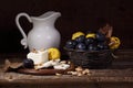 Still life with cheese, quince , plums and white pitcher Royalty Free Stock Photo