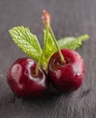 Still life with cherries in a copper mug also in a steel cup