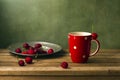 Still life with cherries and red cup Royalty Free Stock Photo
